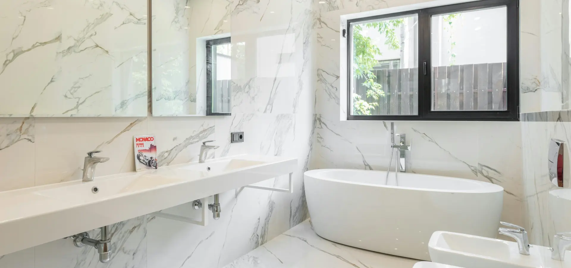 Modern bathroom with a freestanding bathtub and double washbasin in Berlin